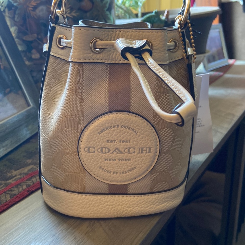 Light khaki and chalk, mini bucket bag by Coach.